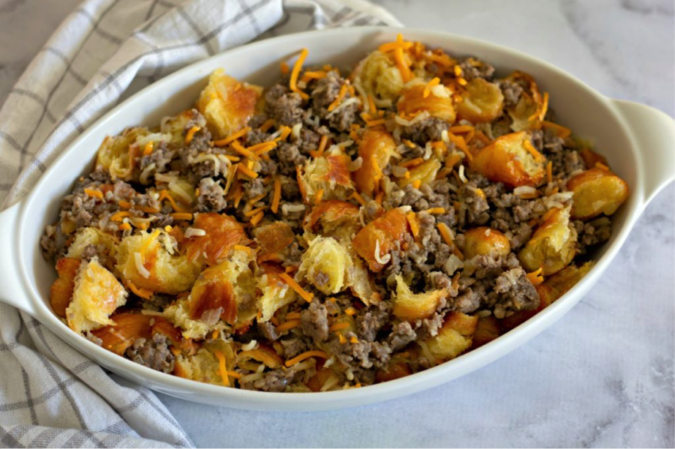 Place sausage, cheese and bread in casserole dish.