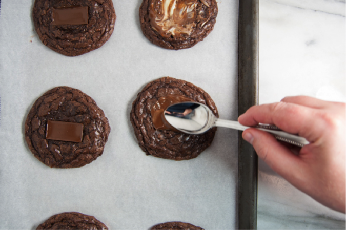 Use back of spoon to melt cookie onto the top of each cookie.